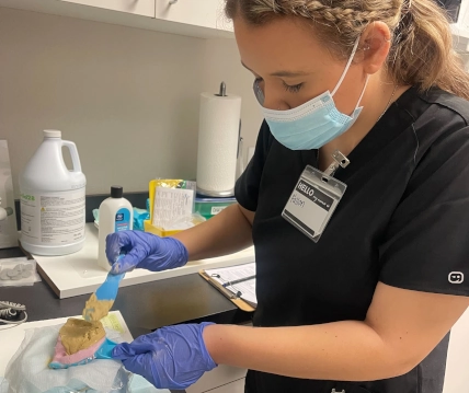 Dental assistant student studying for certification exam